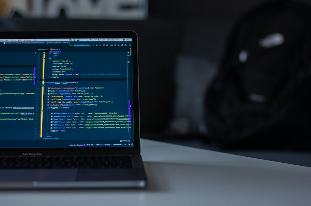 programmer coding on laptop